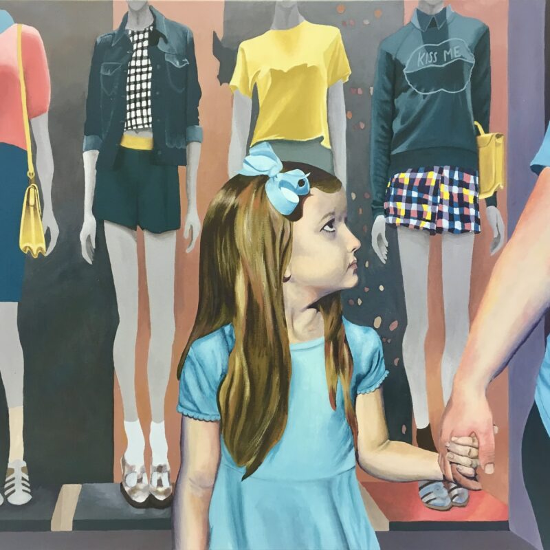 Girl holding mother's hand with thin mannequins behind them